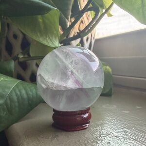 Green and Purple Fluorite Sphere on Wooden Stand